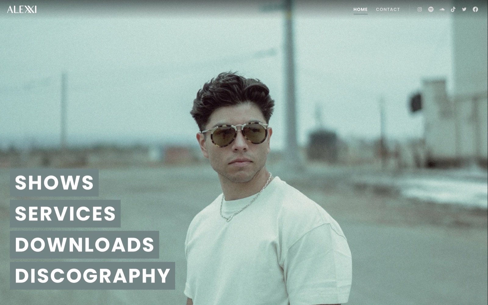 alexxiofficial.com homepage: Alexxi in sunglasses with links to shows, services, downloads, and discography